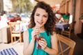 Woman in round sunglasses with cocktail at cafe terrace having fun Royalty Free Stock Photo