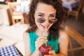 Woman in round sunglasses with cocktail at cafe terrace having fun Royalty Free Stock Photo