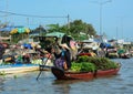 A woman rowing the boat at floating market in Can Tho, Vietnam