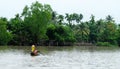 A woman rowing boat on the river in Mekong Delta, Vietnam