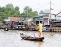 A woman rowing small boat on Mekong river in Tra Vinh, Vietnam