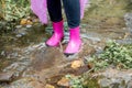 Woman in rubber boots and a raincoat walking in the rain