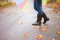 Woman in rubber boots walking with umbrella in a rainy autumn day Royalty Free Stock Photo