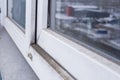 A woman in a rubber glove points to the mold. Plastic window and window sill in mold and dirt. Fungus and dampness at the wet Royalty Free Stock Photo