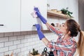 Woman in rubber gloves cleaning kitchen cabinet Royalty Free Stock Photo