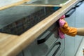 Woman in rubber gloves and cleaning the kitchen counter with sponge Royalty Free Stock Photo