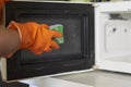 Cleaning microwave in the kitchen Royalty Free Stock Photo