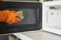 Cleaning microwave in the kitchen Royalty Free Stock Photo