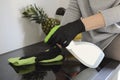 Woman with rubber protective gloves cleans the stove, induction plate  in the kitchen with the cleaning fluid. Royalty Free Stock Photo