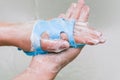 Woman rubs her hands with a blue washcloth. Hand washing with soap. White foam and hands close-up. Cleaning your hands with a Royalty Free Stock Photo