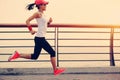 Woman runner athlete running at seaside road Royalty Free Stock Photo