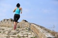 Woman runner athlete running on trail at chinese great wall Royalty Free Stock Photo