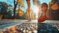 Woman runner feet running on the road at sunrise closeup on shoe