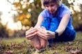 Woman runner hold her sports injured leg outdoor. Sport, medicine and people concept Royalty Free Stock Photo
