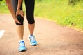 Woman runner holder her sports injured legs Royalty Free Stock Photo