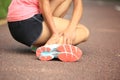Woman runner holder her twisted ankle
