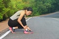 Woman runner hurting holding painful sprained ankle