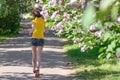 Woman runner jogging in spring park with lilac blossom, morning run outdoors, fitness and running Royalty Free Stock Photo