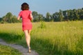 Woman runner jogging on trail outdoors, spring running