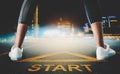 Woman runner legs standing on a start sign ready to run to goal and freedom on modern night city skyline for motivation Royalty Free Stock Photo