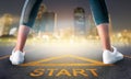 Woman runner legs standing on a start sign ready to run to goal and freedom on modern night city skyline for motivation Royalty Free Stock Photo