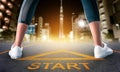 Woman runner legs standing on a start sign ready to run to goal and freedom on Tokyo night city skyline for motivation begining