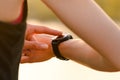 Woman Runner Resting on the Trail at Sunset and Using Smartwatch. Closeup of Hands with Smart Watch. Sports Concept Royalty Free Stock Photo