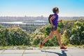 Woman runner run commutes to work with backpack, city morning run commuting and fitness concept Royalty Free Stock Photo