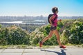 Woman runner run commutes to work with backpack, city morning run commuting and fitness concept Royalty Free Stock Photo