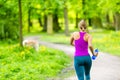 Woman runner running jogging in summer park Royalty Free Stock Photo
