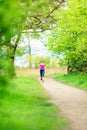 Woman runner running jogging in summer park Royalty Free Stock Photo