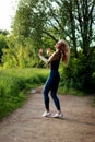 Woman runner running jogging in summer park, waving his hair Royalty Free Stock Photo