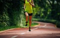 Woman runner running on morning park road workout jogging Royalty Free Stock Photo