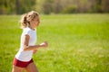 Woman runner runs - workout in spring