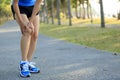 Woman runner sports injured knee