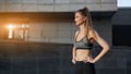 Woman runner standing before exercising urban city background Royalty Free Stock Photo