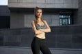Woman runner standing before exercising urban city background Royalty Free Stock Photo
