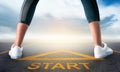 Woman runner is standing on a start sign ready to run to goal and freedom on bluesky for motivation begining Royalty Free Stock Photo