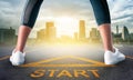 Woman runner standing on a start sign ready to run to goal and freedom on modern city for motivation begining concept