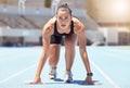 Woman runner start position on race track, competition or cardio for healthy exercise, workout and fitness in stadium Royalty Free Stock Photo
