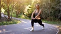 Woman runner stretching legs before exercising summer park  morning Royalty Free Stock Photo