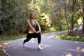 Woman runner stretching legs before exercising summer park  morning Royalty Free Stock Photo