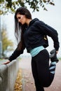 Woman runner stretching legs before run. Royalty Free Stock Photo