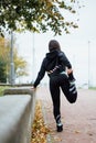 Woman runner stretching legs before run. Royalty Free Stock Photo