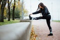 Woman runner stretching legs before run. Royalty Free Stock Photo