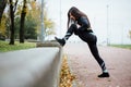 Woman runner stretching legs before run. Royalty Free Stock Photo