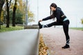 Woman runner stretching legs before run. Royalty Free Stock Photo