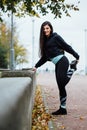 Woman runner stretching legs before run. Royalty Free Stock Photo