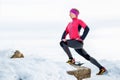 Woman runner stretching legs before run. Young athlete woman working out. Royalty Free Stock Photo