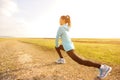 Woman runner stretching legs